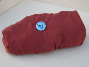 bundle of tools wrapped up in red fabric and pinned with a small button