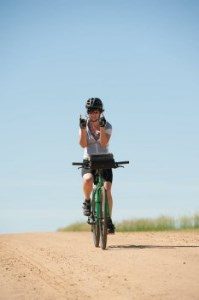 Amy biking on gravel road