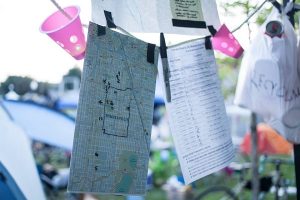 Maps and riding plans hanging up on a clothes line
