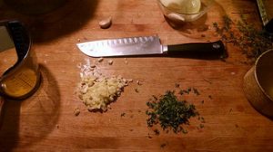 chopped herbs and ingredients on a cutting board