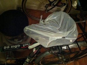 bicycle seat wrapped in a platic bag