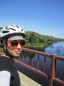 low, helmet and sunglasses on, overlooking the Mississippi River