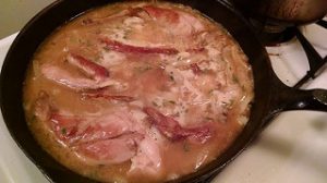rabbit cooking in a sauce, in a pan