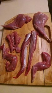 Cuts of rabbit meat on a cutting board