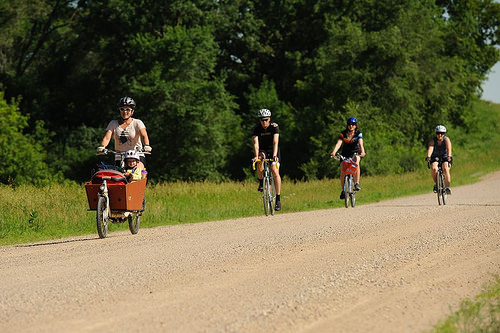 Four riders going down a gravel road