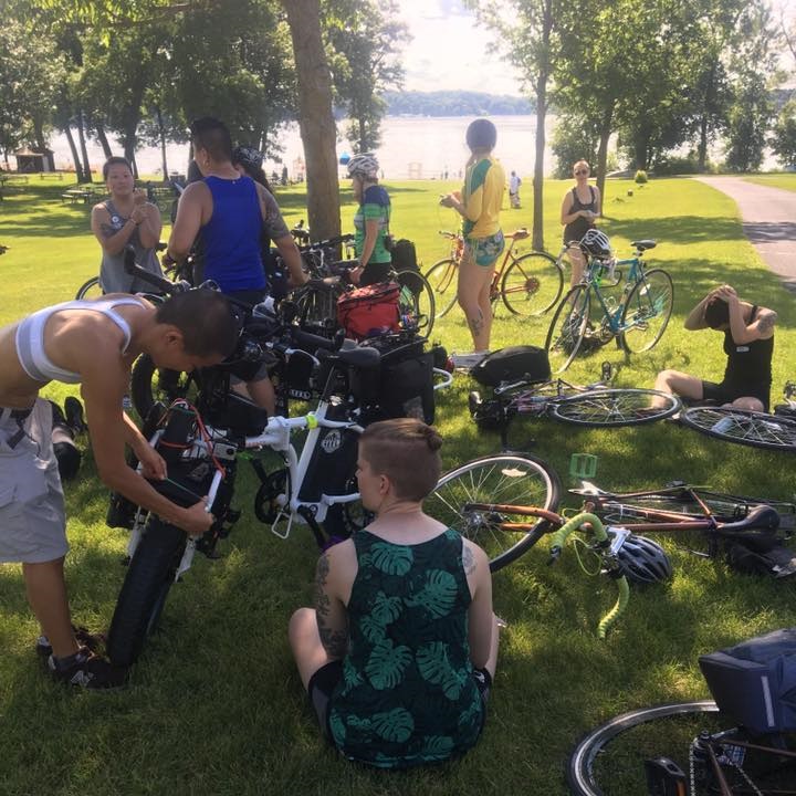 group of riders stopped near a lake