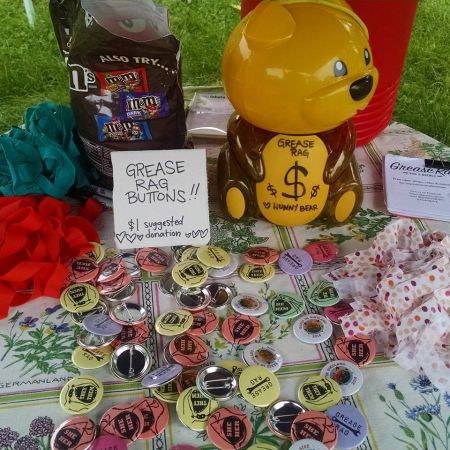 a spread of pronoun buttons with a yellow donation bucket in the shape of a bear