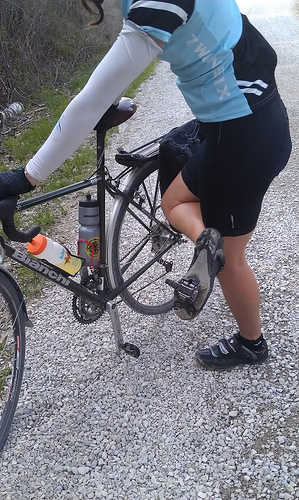 rider showing the bottom of foot with pedal attached, pedal broke or separated from bike crank