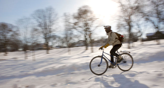 Low on a bike riding down a hill in the winter