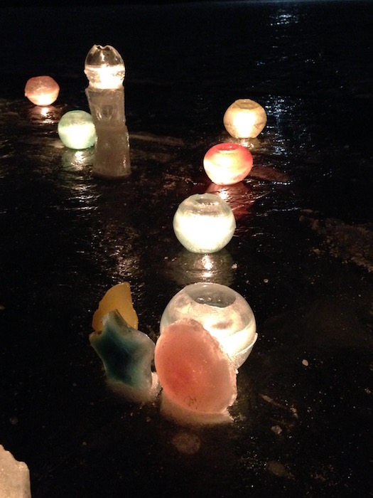 ice candle holders lit up by candles inside them