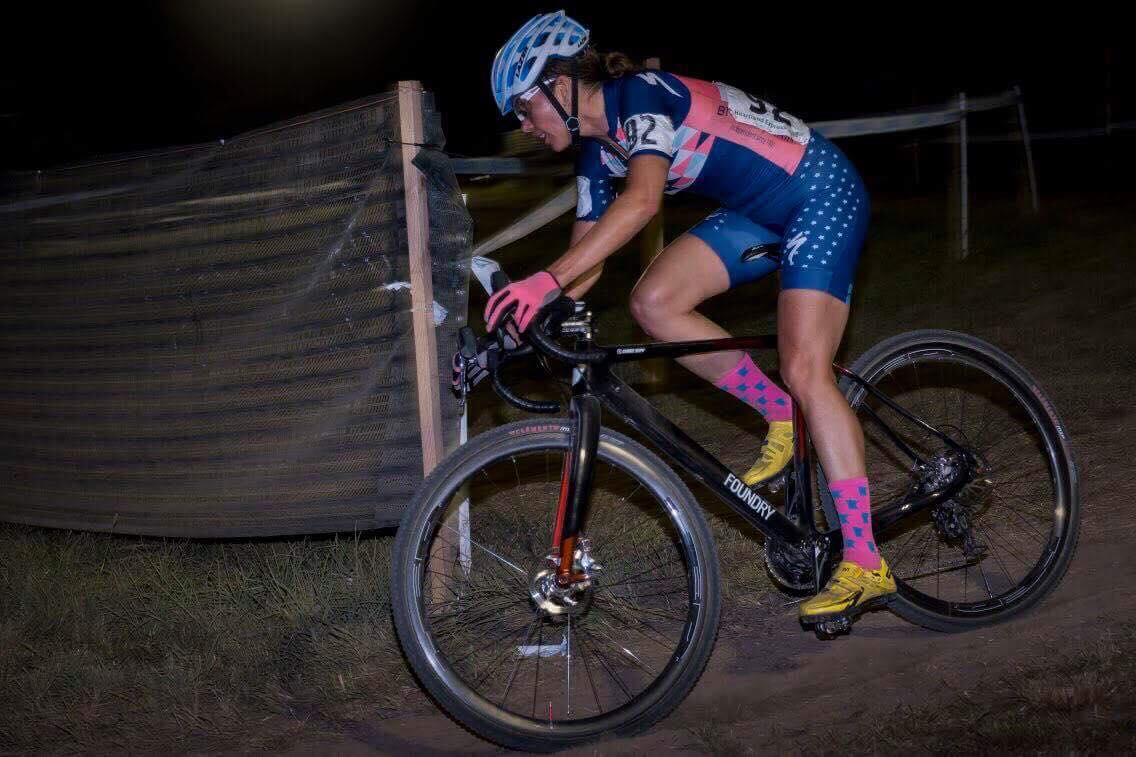 rider cycling down hill in the dark